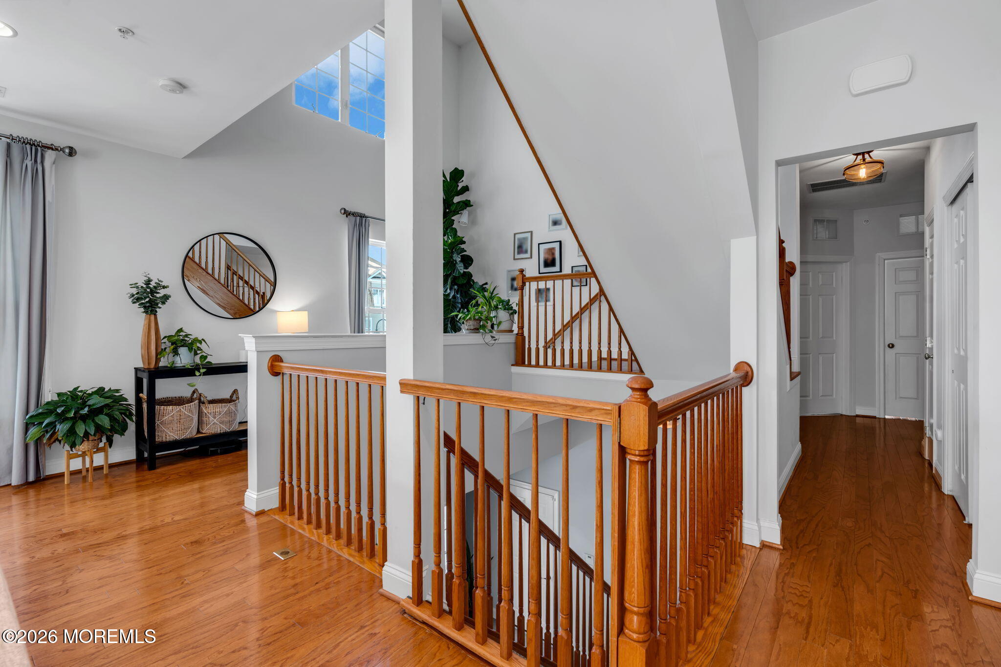 712 Abby Road Middletown, NJ 07748 - Photo 3 of 44 a view of staircase with lots of frames on wall and wooden floor