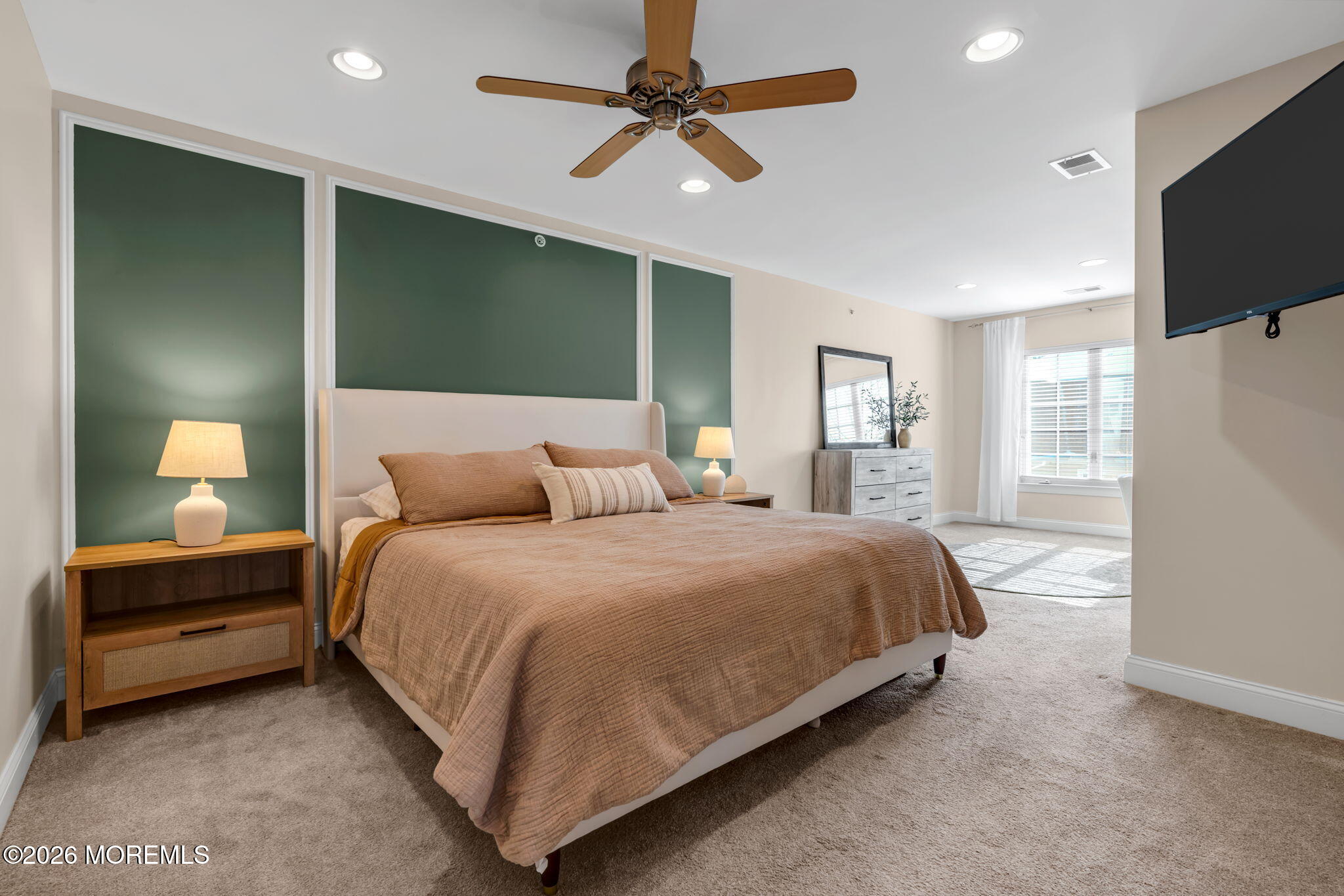 712 Abby Road Middletown, NJ 07748 - Photo 31 of 44 a bedroom with a bed and a flat tv screen on dresser