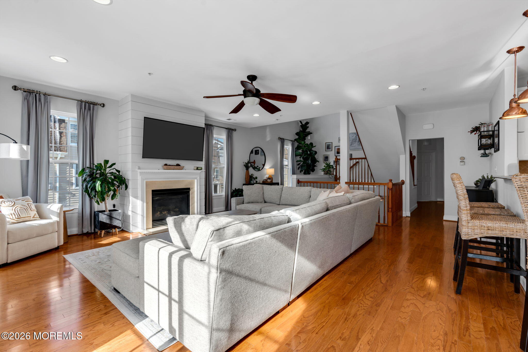 712 Abby Road Middletown, NJ 07748 - Photo 43 of 44 a living room with furniture a fireplace and a flat screen tv