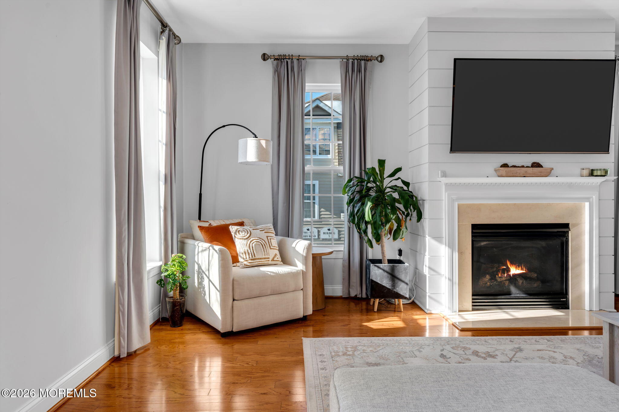 712 Abby Road Middletown, NJ 07748 - Photo 9 of 44 a living room with furniture a flat screen tv and a fireplace
