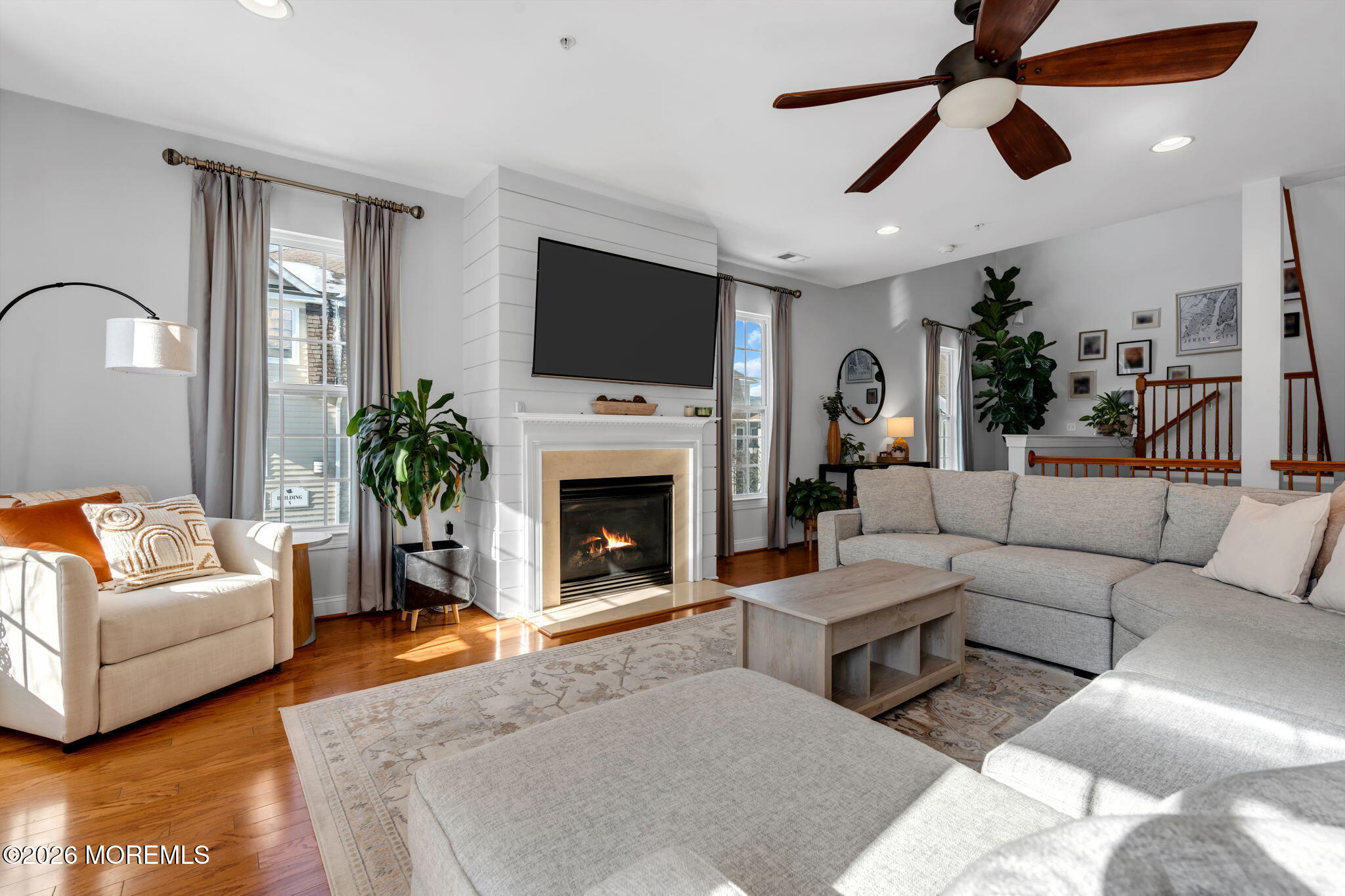 712 Abby Road Middletown, NJ 07748 - Photo 10 of 44 a living room with furniture a flat screen tv and a fireplace