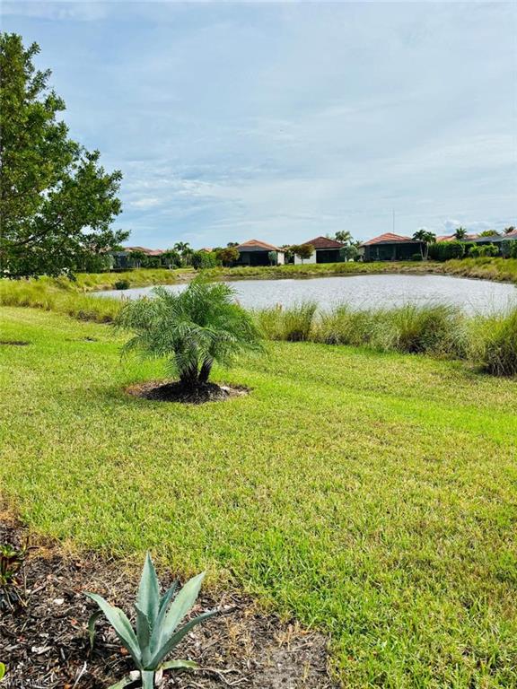 1599 Marton Court Naples, FL 34113 - Photo 22 of 22 a view of a lake with houses in the back