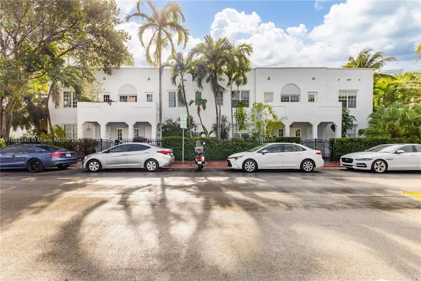 a view of a cars park in front of a building