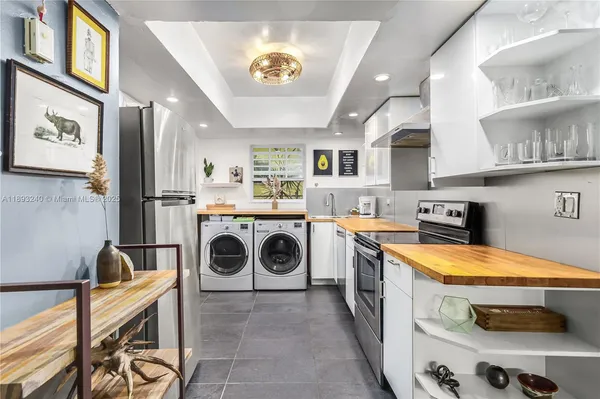 a utility room with sink dryer and washer