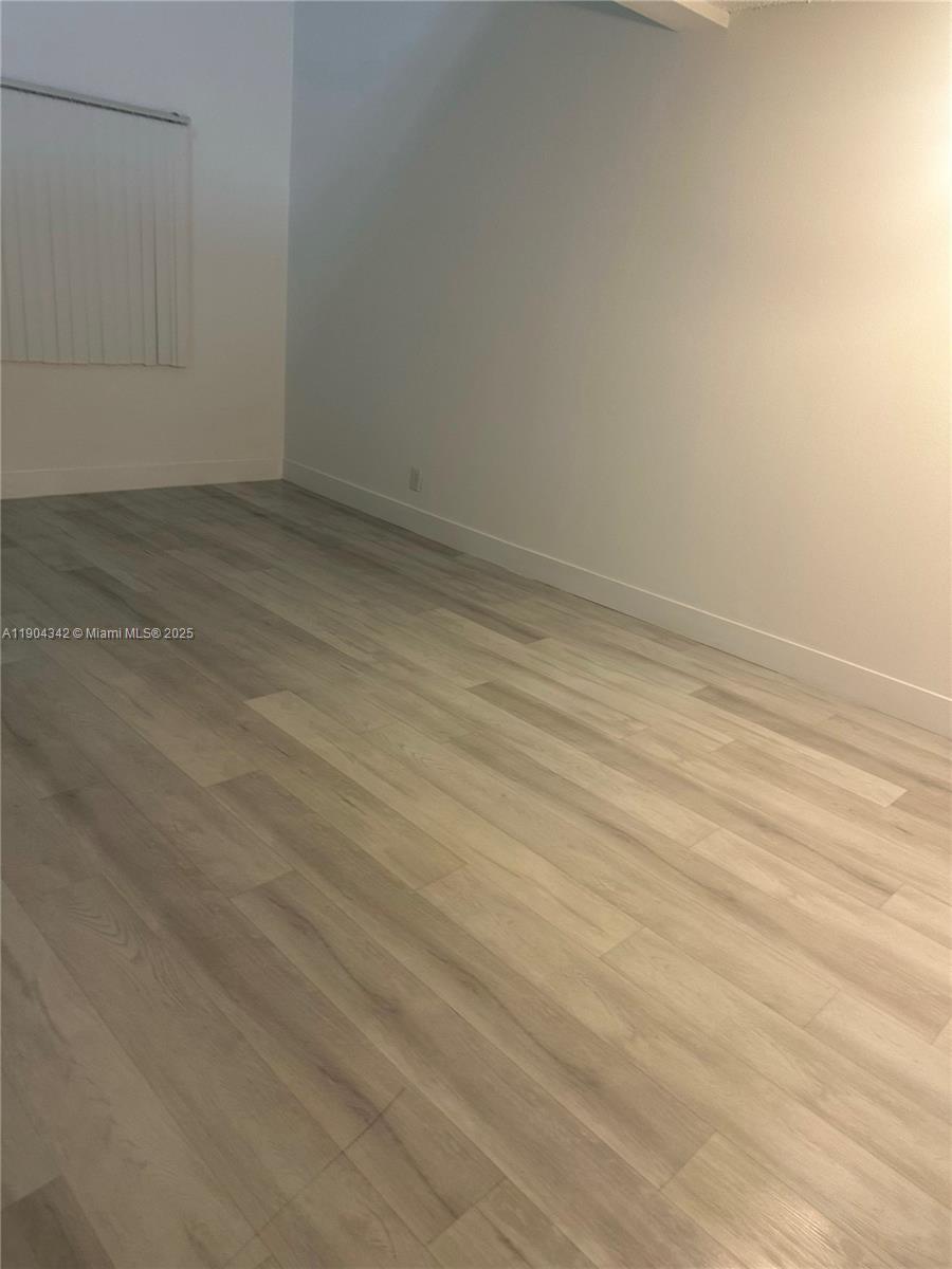 18007 Northwest 68th Avenue, Unit U103 Hialeah, FL 33015 - Photo 2 of 9 a view of an empty room