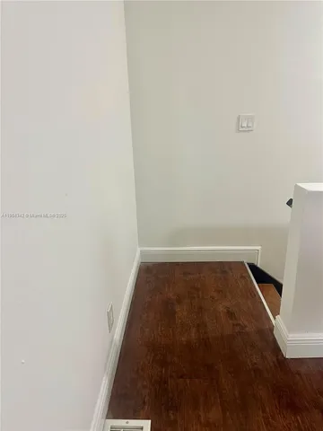 a view of walk in closet with wooden floor