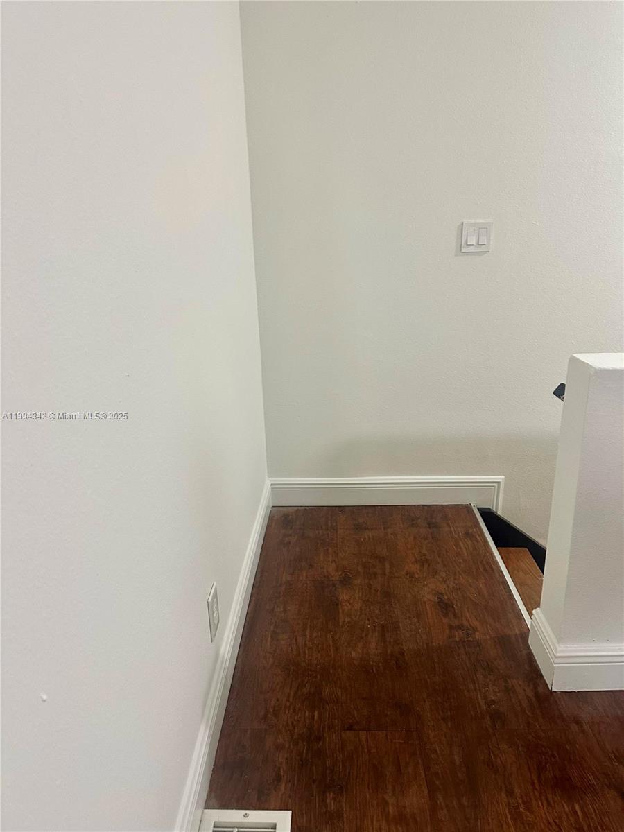 18007 Northwest 68th Avenue, Unit U103 Hialeah, FL 33015 - Photo 4 of 9 a view of walk in closet with wooden floor