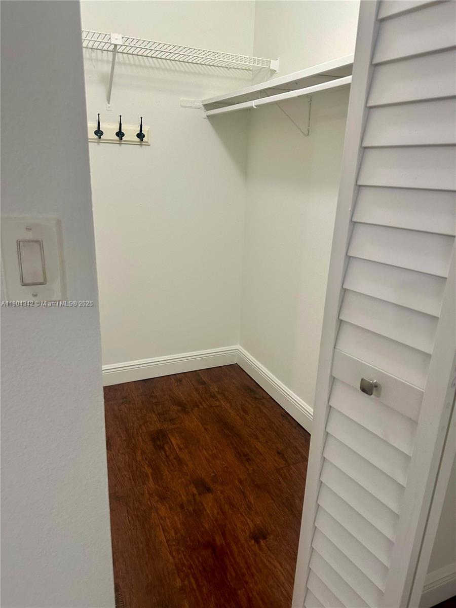 18007 Northwest 68th Avenue, Unit U103 Hialeah, FL 33015 - Photo 6 of 9 a view of walk in closet