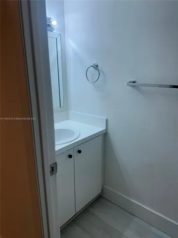 a white toilet sitting next to a white sink