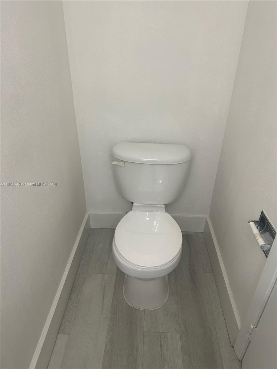 18007 Northwest 68th Avenue, Unit U103 Hialeah, FL 33015 - Photo 9 of 9 a white toilet sitting next to a white sink