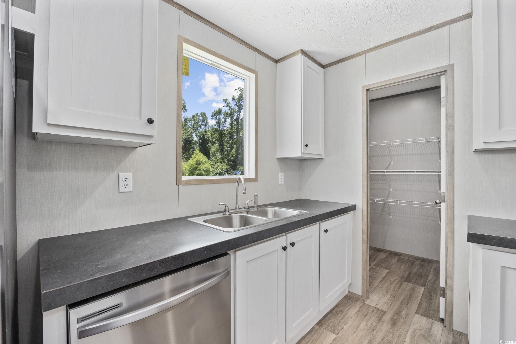 491 North Green Sea Road Loris, SC 29569 - Photo 24 of 39 Kitchen with dishwasher, a sink, dark countertops,