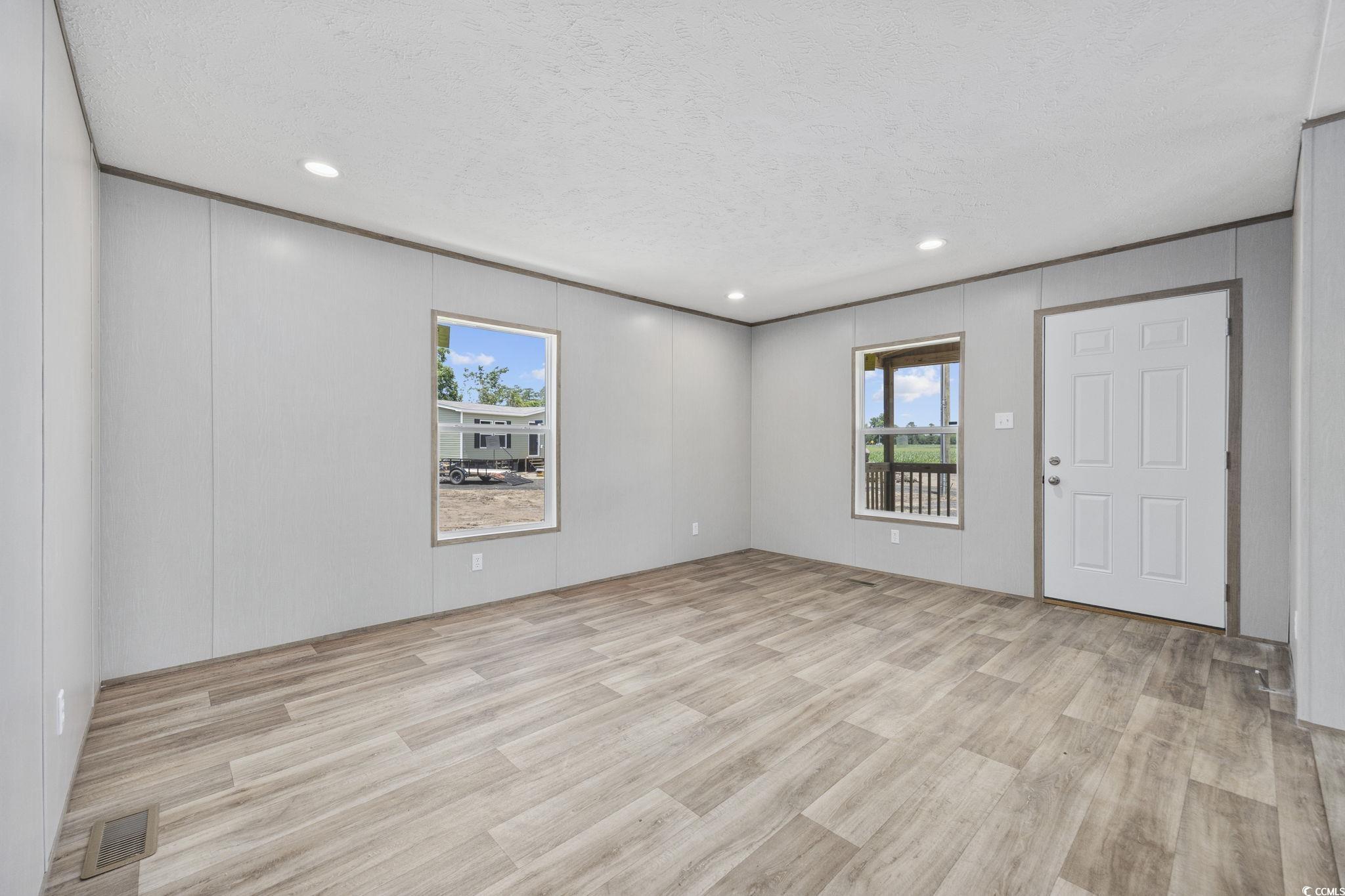 491 North Green Sea Road Loris, SC 29569 - Photo 31 of 39 Spare room with wood finished floors, a textured c