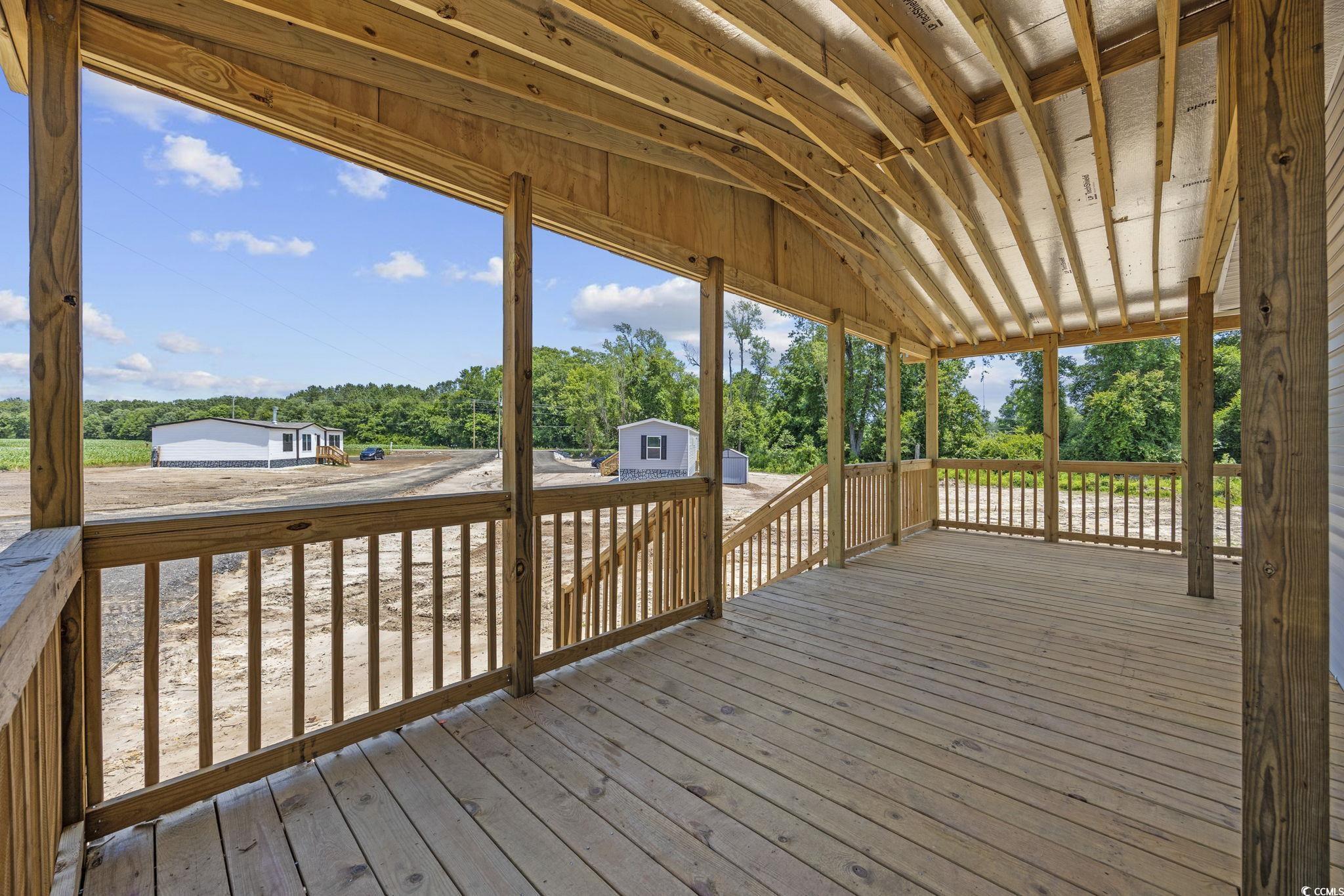491 North Green Sea Road Loris, SC 29569 - Photo 36 of 39 Wooden terrace with view of wooded area and an out