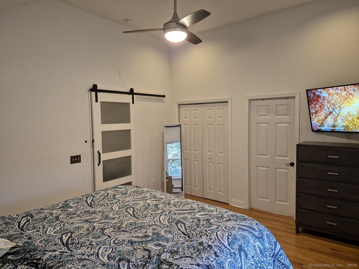 34 Transylvania Road Woodbury, CT 06798 - Photo 8 of 17 a bedroom with a bed and a flat screen tv