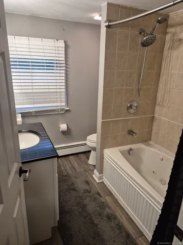 a bathroom with a bathtub and a shower