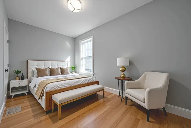 a bedroom with a bed and a chair