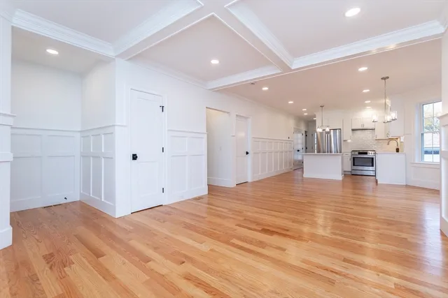 a view of empty room with wooden floor