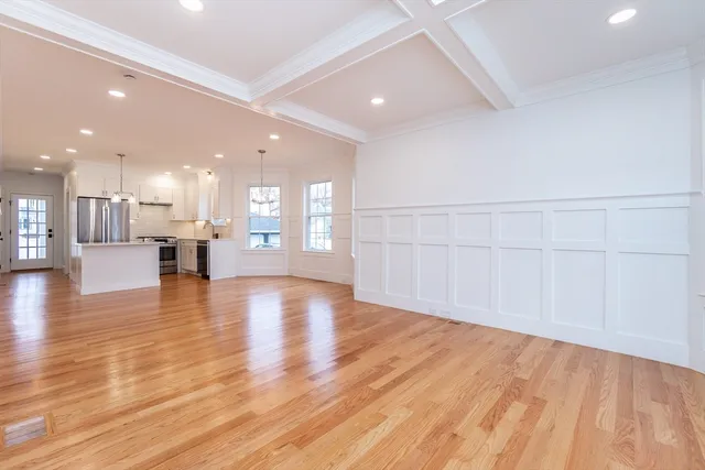 a view of an empty room with a kitchen