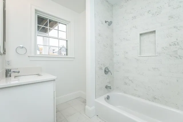 a white bath tub sitting next to a white sink
