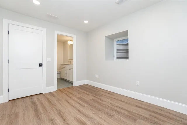 an empty room with wooden floor and closet