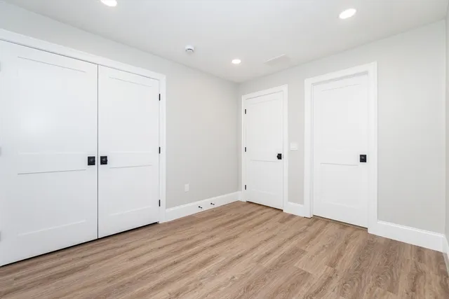 a view of room with wooden floor