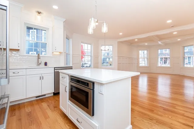 a kitchen with a stove and a white kitchen island