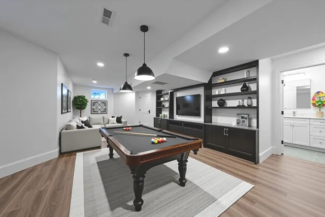a living room with furniture a table and kitchen view