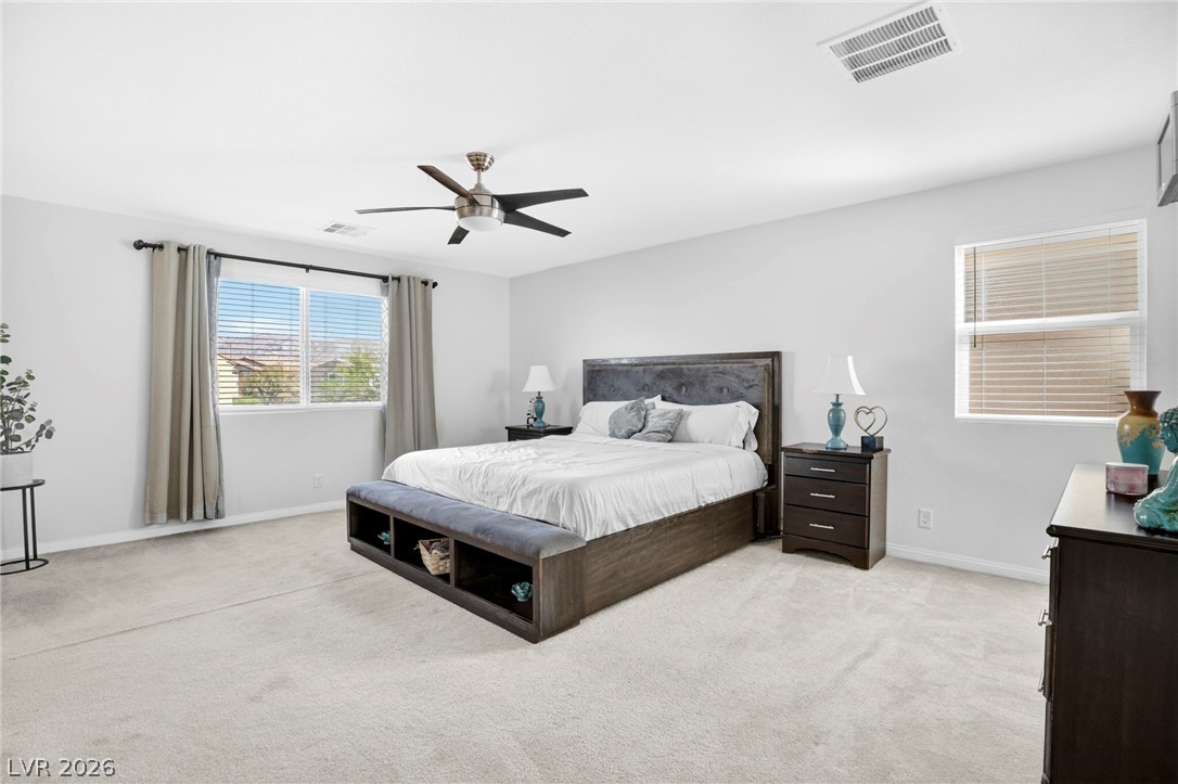 6281 Angora Peak Lane Las Vegas, NV 89115 - Photo 16 of 34 Discover comfort in this bedroom featuring a ceiling fan and natural light.