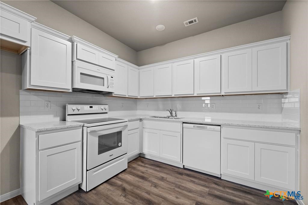 313 Elbert Lane, Unit B Harker Heights, TX 76548 - Photo 3 of 10 a kitchen with cabinets appliances a sink and a counter top