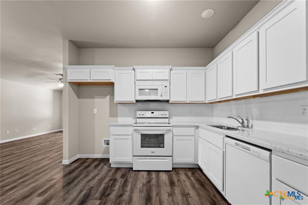 313 Elbert Lane, Unit B Harker Heights, TX 76548 - Photo 4 of 10 a kitchen with a sink cabinets stainless steel appliances and a window