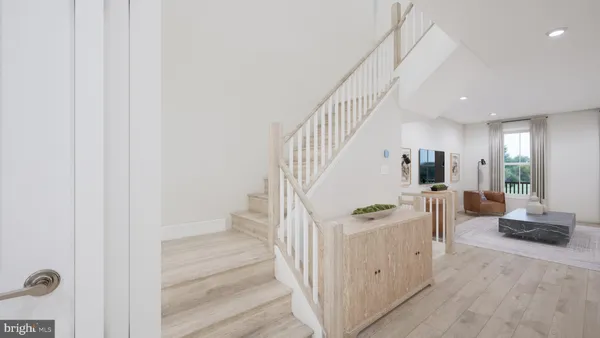 a view of entryway and hall with wooden floor