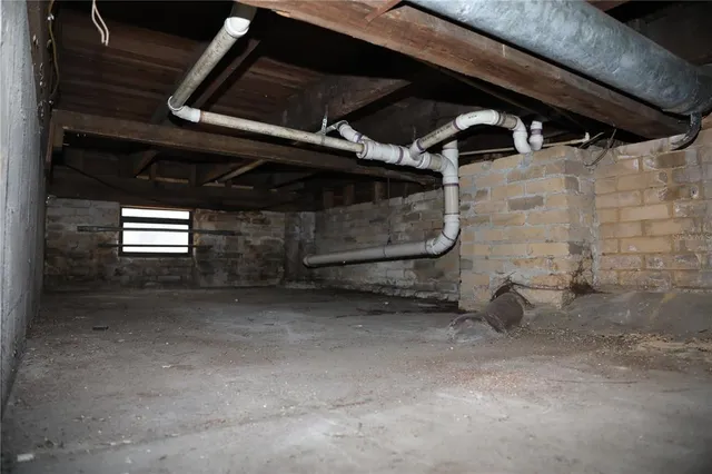 a living room with furniture a rug and a wall painting