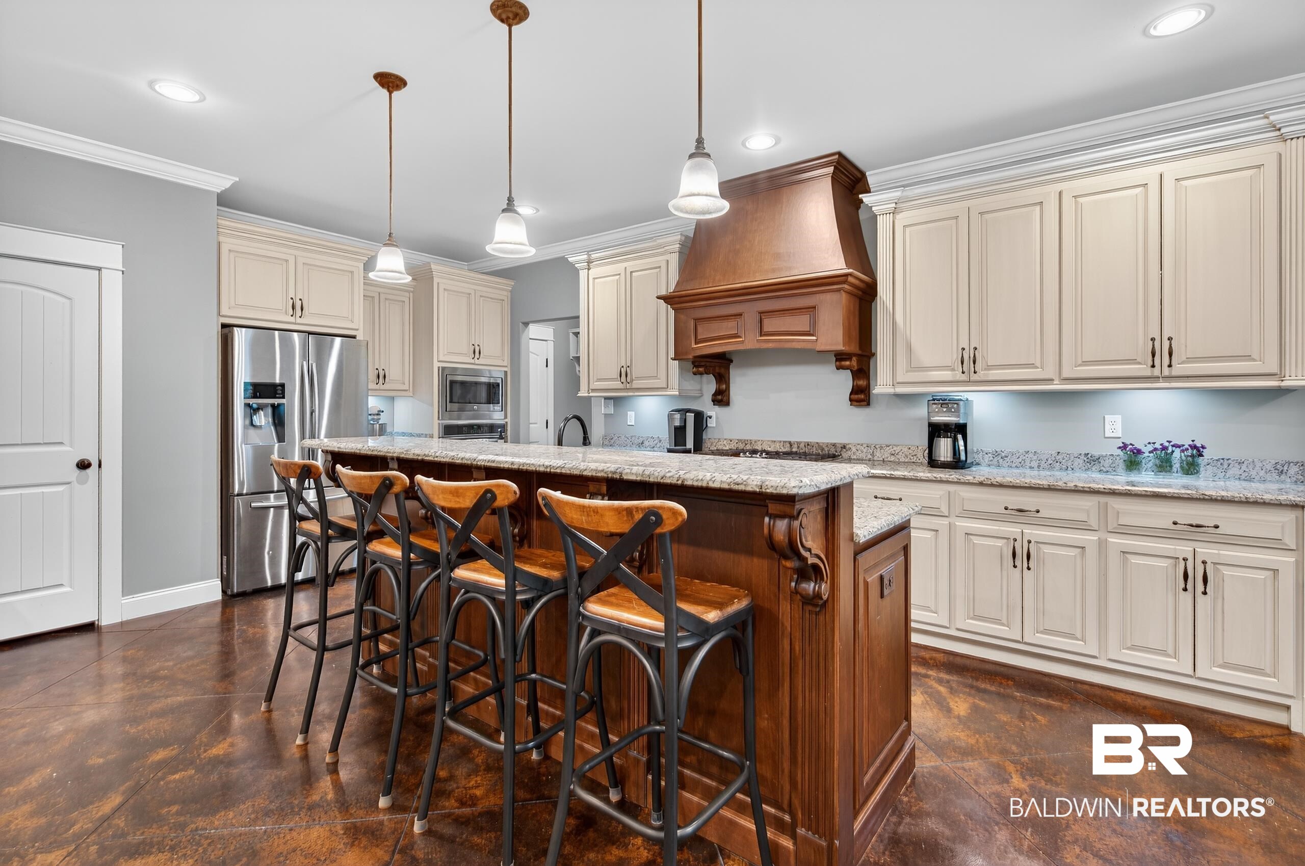5517 Rabbit Creek Drive Theodore, AL 36582 - Photo 5 of 33 Kitchen with cream cabinetry, hanging light fixtures, a kitchen breakfast bar, appliances with stainless steel finishes, and light stone countertops
