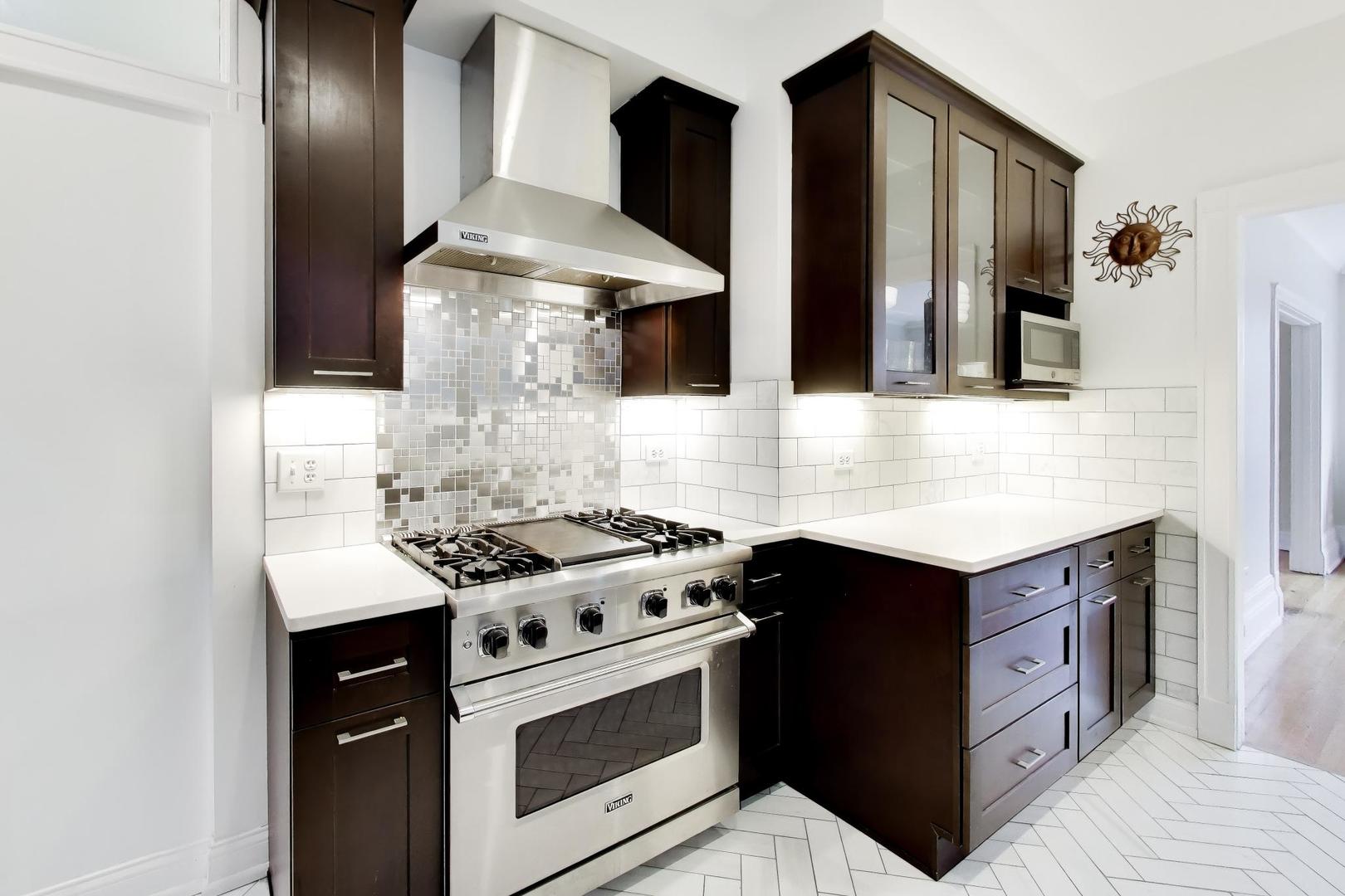 825 East Drexel Square, Unit 2 Chicago, IL 60615 - Photo 11 of 25 a kitchen with stainless steel appliances granite countertop a stove and a refrigerator