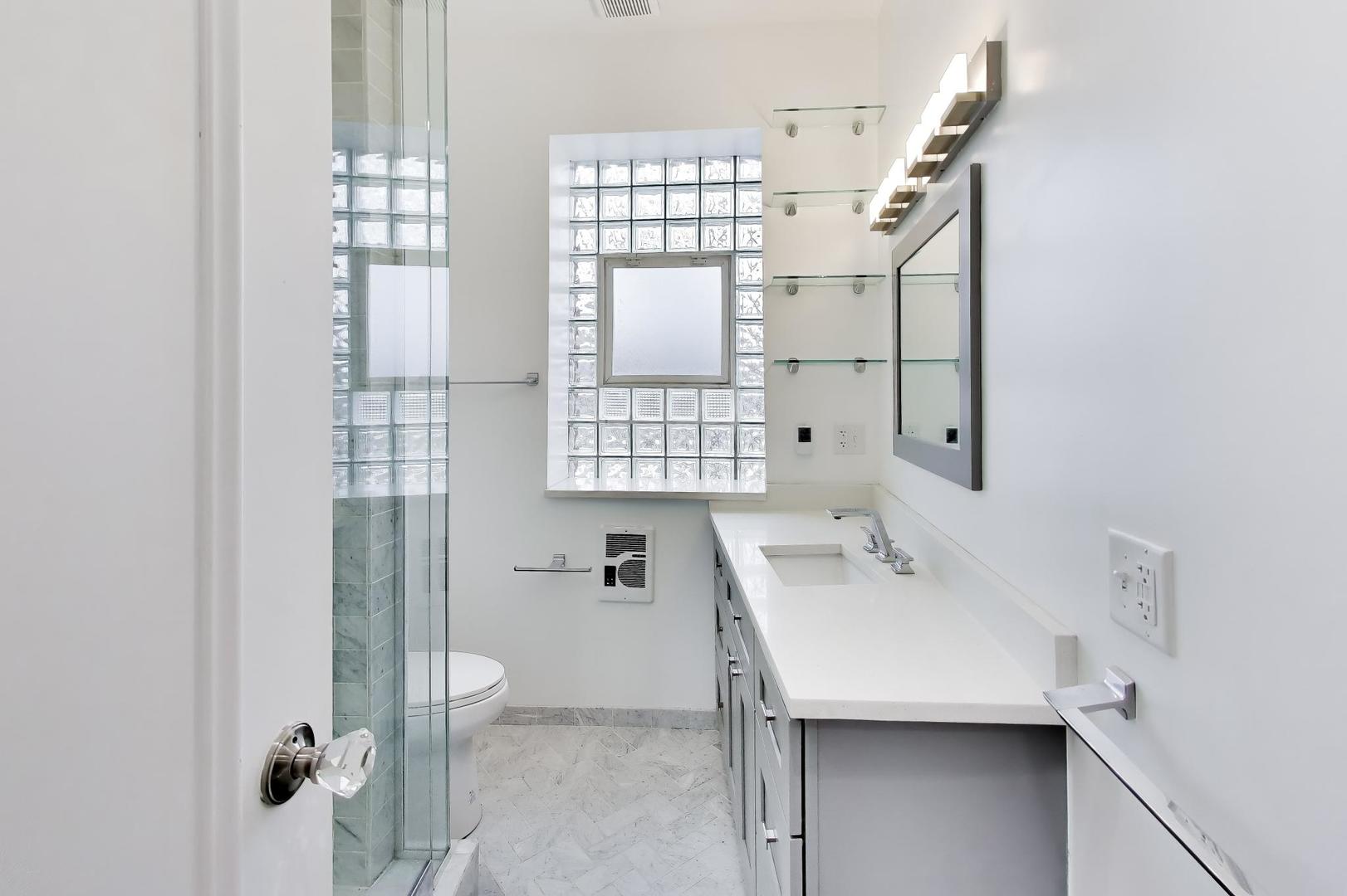 825 East Drexel Square, Unit 2 Chicago, IL 60615 - Photo 17 of 25 a bathroom with a sink and a mirror