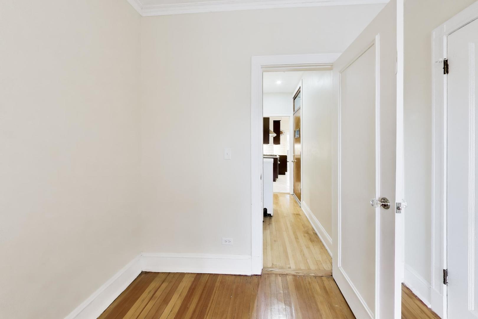 825 East Drexel Square, Unit 2 Chicago, IL 60615 - Photo 20 of 25 a view of a hallway with wooden floor and staircase