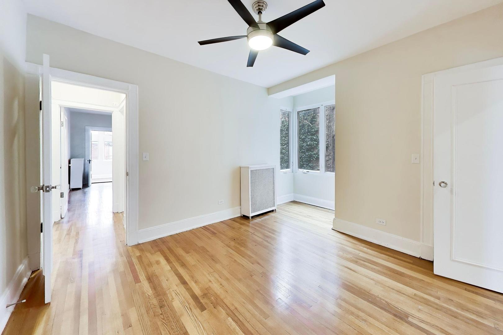 825 East Drexel Square, Unit 2 Chicago, IL 60615 - Photo 23 of 25 wooden floor in an empty room with a window