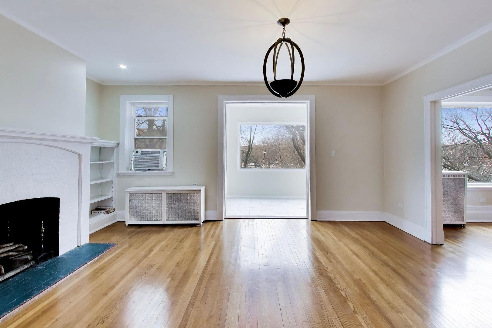 825 East Drexel Square, Unit 2 Chicago, IL 60615 - Photo 4 of 25 a view of livingroom with furniture wooden floor window and fireplace