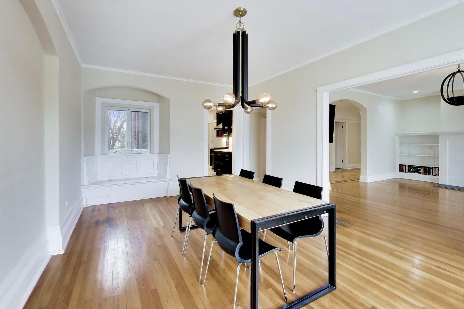 825 East Drexel Square, Unit 2 Chicago, IL 60615 - Photo 9 of 25 a view of a dining room with furniture and wooden floor
