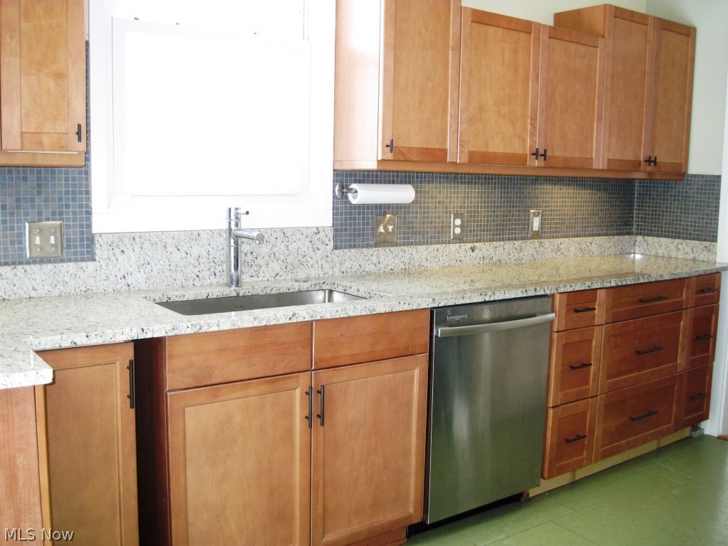 1590 Rydalmount Road Cleveland Heights, OH 44118 - Photo 6 of 16 SHARP GRANTIE COUNTERS, NEW CABINETS, AND STYLISH TILE ARE JUST SOME OF THE UPDATES IN THIS DREAM KITCHEN