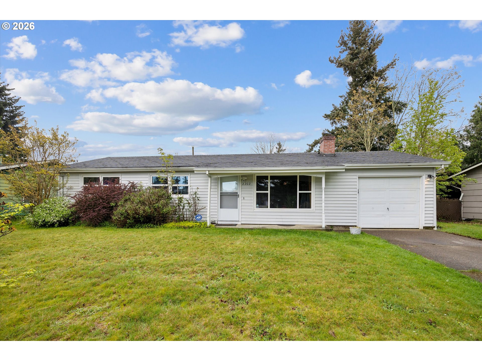 2202 Southeast 178th Place Portland, OR 97233 - Photo 1 of 30 a view of a yard in front of a house with a large tree
