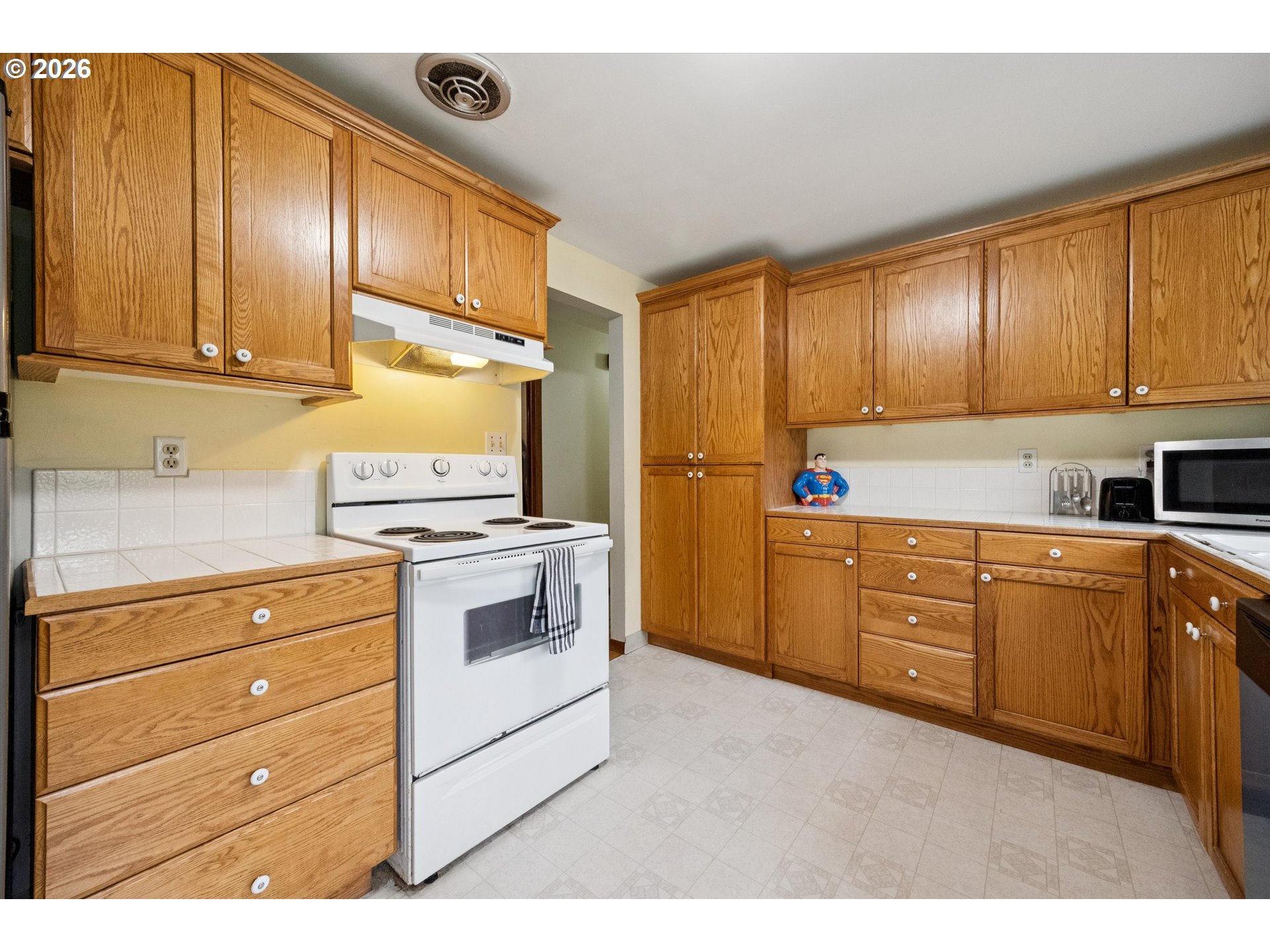 2202 Southeast 178th Place Portland, OR 97233 - Photo 13 of 30 a kitchen with granite countertop cabinets stainless steel appliances and wooden floor
