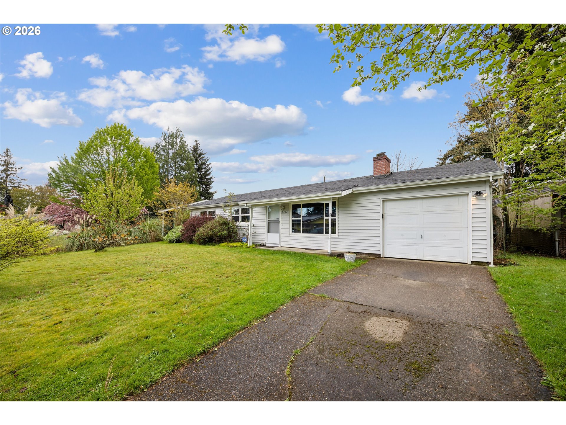 2202 Southeast 178th Place Portland, OR 97233 - Photo 5 of 30 a front view of a house with a yard and garage