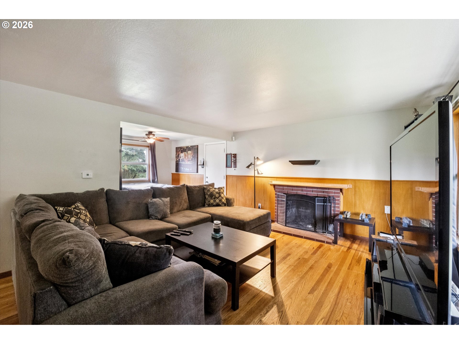 2202 Southeast 178th Place Portland, OR 97233 - Photo 6 of 30 a living room with furniture and a fireplace