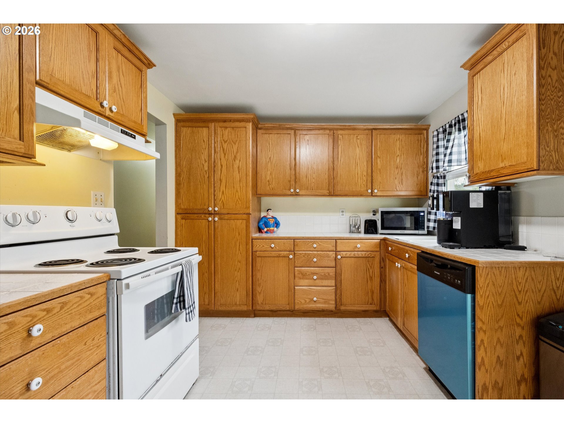 2202 Southeast 178th Place Portland, OR 97233 - Photo 9 of 30 a kitchen with a stove a sink and a microwave