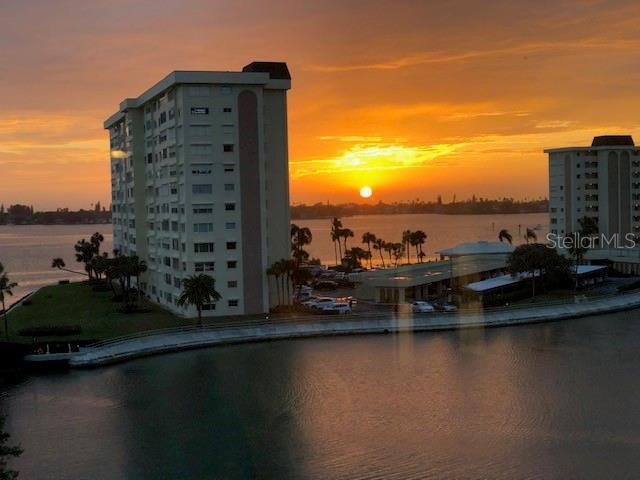 4575 Cove Circle, Unit 1003 St. Petersburg, FL 33708 - Photo 1 of 1 a view of a lake with a large building in the background