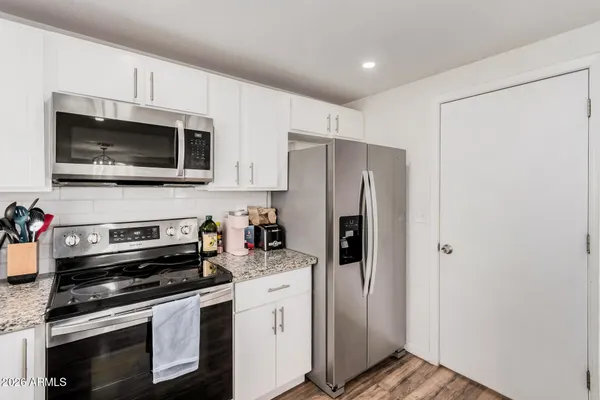 a kitchen with stainless steel appliances a refrigerator stove and microwave