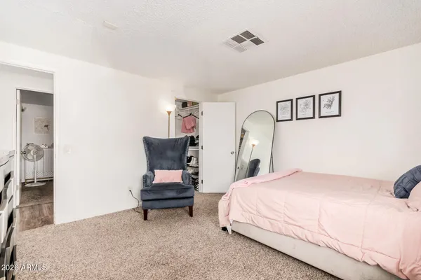 a bedroom with a bed and a chair