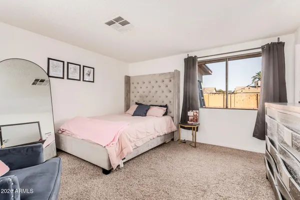 a bedroom with a bed and window