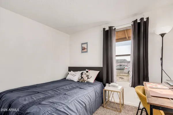 a bedroom with a bed and a window